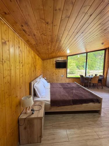 a bedroom with a bed and a wooden ceiling at Hotel Mirioni in Oni