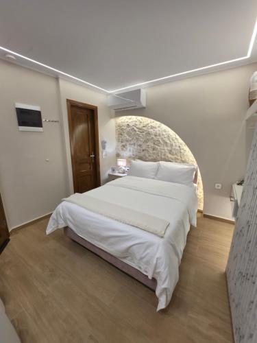 a bedroom with a large white bed in a room at LUM Luxury Studios in Rethymno