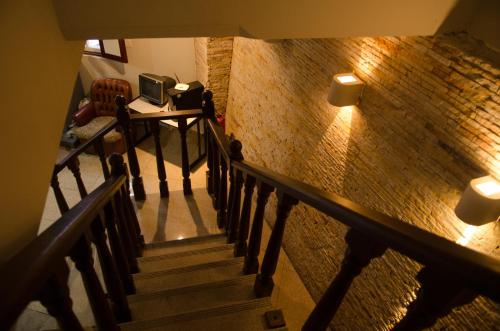 a staircase with two lights on a brick wall at Pousada dos Bandeirantes in Ouro Preto
