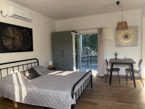 a bedroom with a bed and a table with chairs at Apartmani Stellar in Malinska