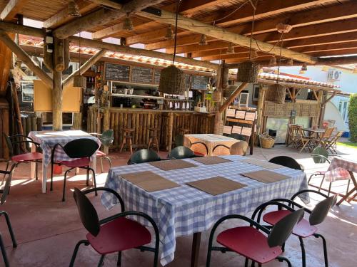 a table and chairs in a large room with a table and chairsktop at Ponte Pedra Melides -Nature & Ocean- Adults Only in Melides