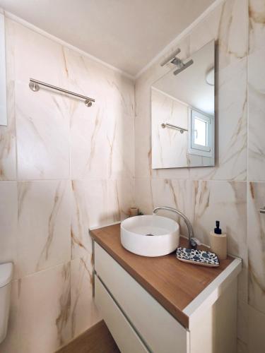 a bathroom with a sink and a mirror at Loft Suites - by Avelink in Spata