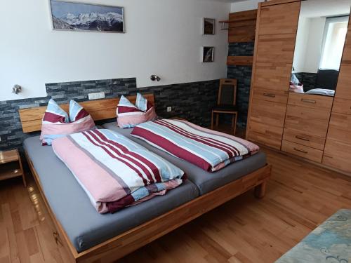 a bedroom with a bed with two pillows on it at Gästehaus Michael in Navis