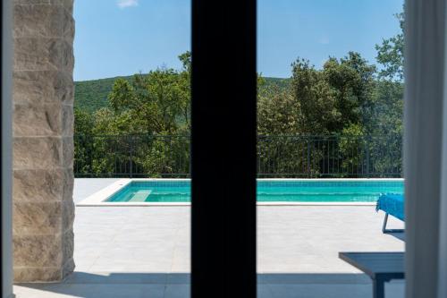 a view of a swimming pool through a window at Villa Montenegrina in Krapina