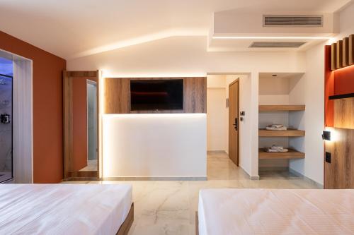 a bedroom with a white bed and orange walls at ZOI Girni - Seaside Hotel in Olympic Beach