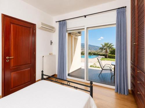 a bedroom with a bed and a large window at Villa Glan Y Mor in Elounda