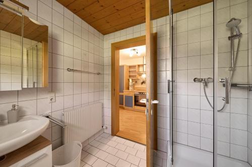 a bathroom with a shower and a sink at Haus Bergharmonie in Tschagguns