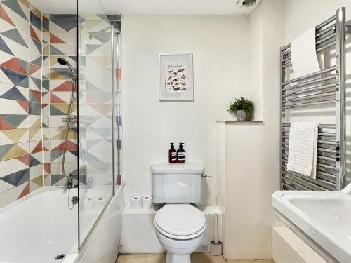 a bathroom with a toilet and a shower at Kiri Cottage Hawkridge in Dulverton