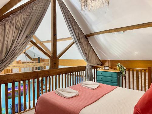 a bedroom with a bed on a balcony at Kiri Cottage Hawkridge in Dulverton