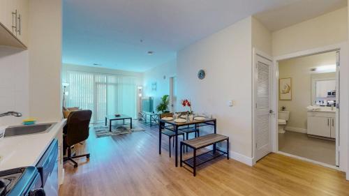 a kitchen and a living room with a table in it at Elegant Home in Stamford