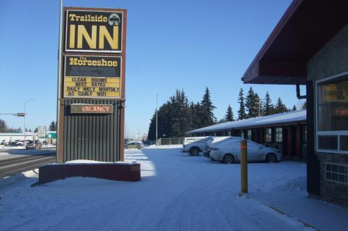 a sign for a inn in a parking lot at Trailside Inn in Lloydminster