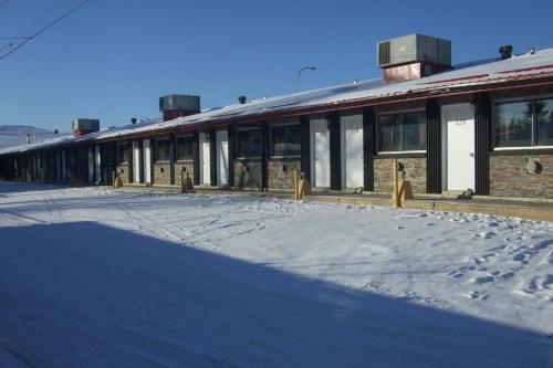 an empty building with snow on the ground at Trailside Inn in Lloydminster