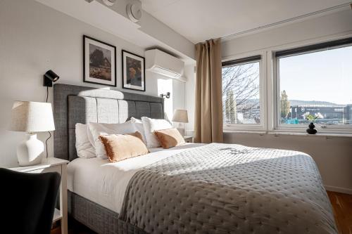 a bedroom with a large bed with a large window at First Hotel Jönköping North in Jönköping