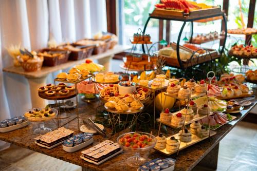 a buffet with many different types of food on a table at Royal Turquesa Boutique Hotel in Búzios