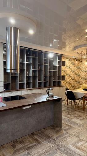 a kitchen with a counter and a dining room at Chayka Home Hotel in Chayky