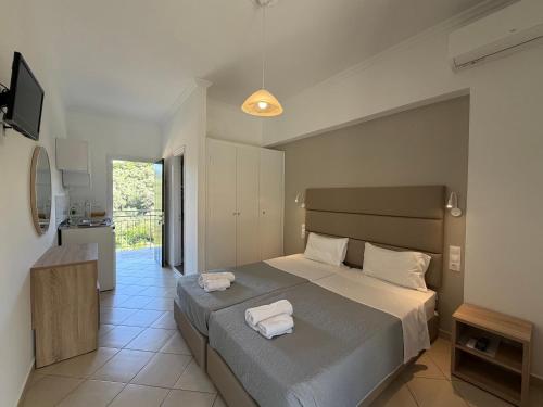 a bedroom with a bed with two towels on it at Anemona Studios in Paleokastritsa