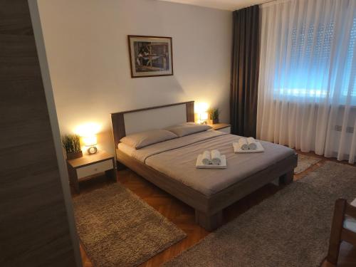 a bedroom with a bed with two towels on it at Apartman Škribulja in Županja