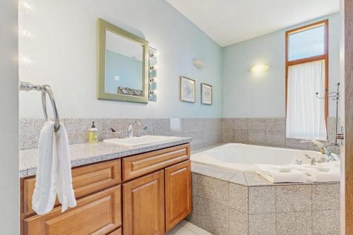 a bathroom with a tub and a sink and a tub and a bath tub at Lake Shore Drive in Franklin