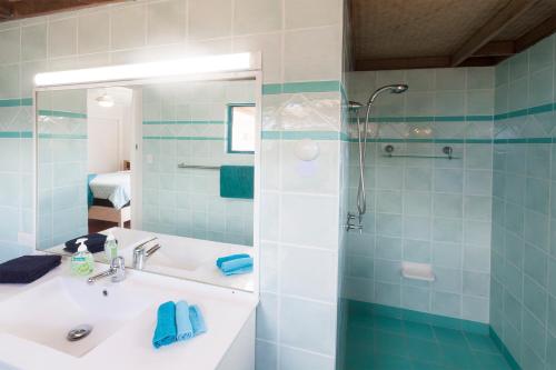 a bathroom with a sink and a shower at White Waves on the Beach in Hastings Point