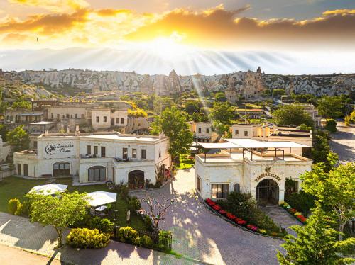 an aerial view of a mansion with mountains in the background at Empire Cave Cappadocia in Göreme