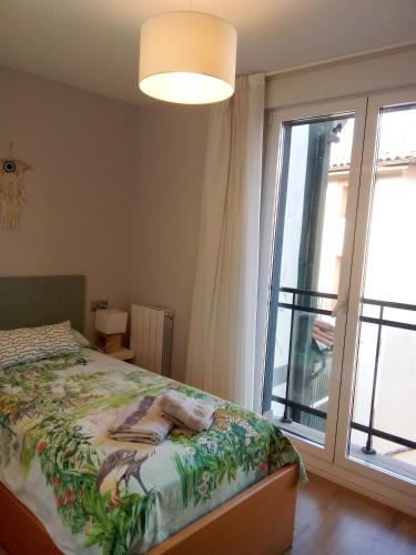 a bedroom with a bed and a large window at APARTAMENTO AKATZ in Mundaka