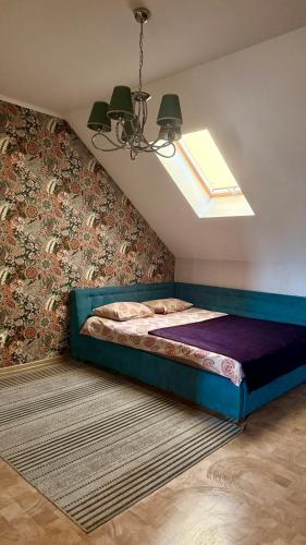 a bedroom with a bed in a room with a window at Chayka Home Hotel in Chayky