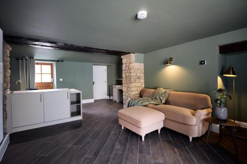 a living room with a couch and a chair at Fuchsia Cottage - Accessible Comfort in Wilton