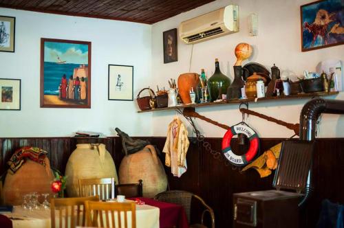 a room with a table and vases on the wall at B&B Lovac in Ulcinj