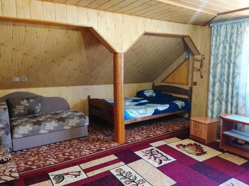 a bedroom with two beds in a room with a roof at Апартаменти з гарним краєвидом in Yablunytsya