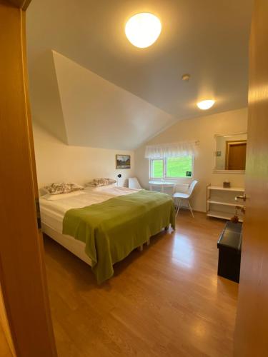 a bedroom with a large bed and a desk at Öndólfsstaðir Farm B&B in Laugar