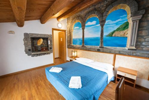 a bedroom with a blue bed and a fireplace at Agriturismo Campo Rosso in Civitella di Romagna