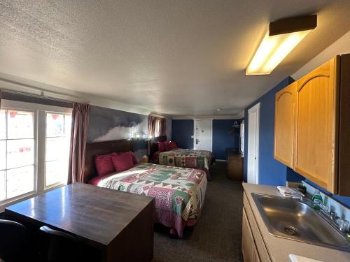 a hotel room with two beds and a sink at Bryce Canyon Resort in Bryce Canyon