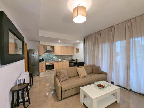 a living room with a couch and a table at Relax en Lloret con Gym y Piscina by Host&Joy in Lloret de Mar