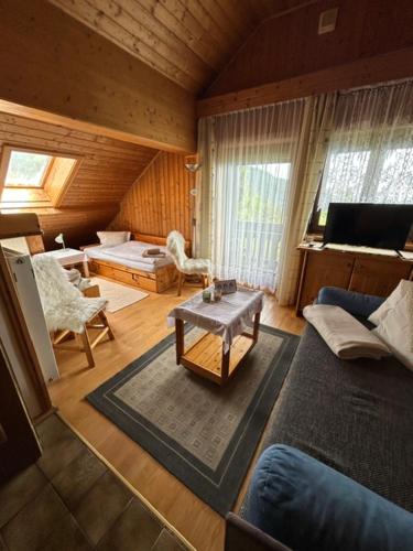 a living room with a couch and a table at Appartments Prinz - Gerlitze in Tobitsch
