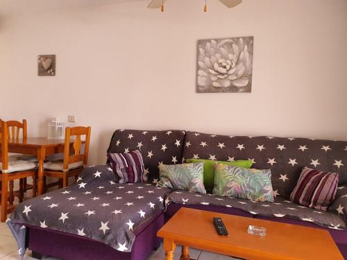 a living room with a couch and a table at Casa Kiara in Costa Calma