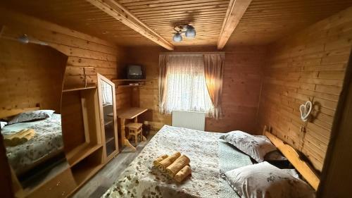 a bedroom with two beds and a window and a desk at Sadyba Dana in Tatariv