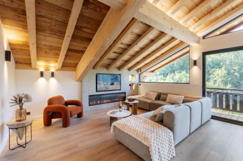 a living room with a couch and a fireplace at Chalet des Granges 12 personnes Spa et cinéma in Morzine