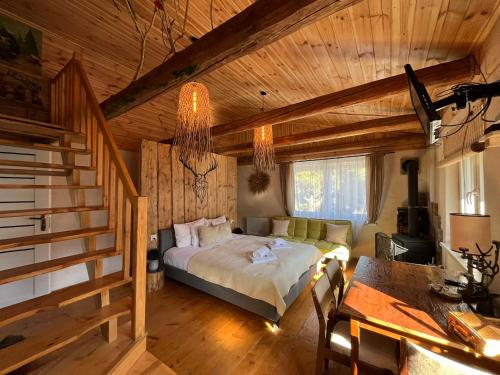 a bedroom with a bed in a room with wooden ceilings at Wąkop 6 Agroturystyka Eco in Nowa Słupia