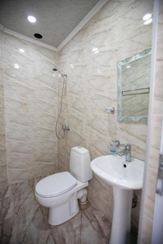 a bathroom with a toilet and a sink at Guest House on Rustaveli 176 in Kobuleti
