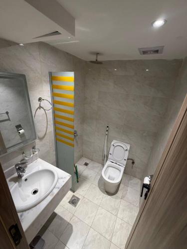 a bathroom with a sink and a toilet at Ritaj Al-Tala'i in Mecca