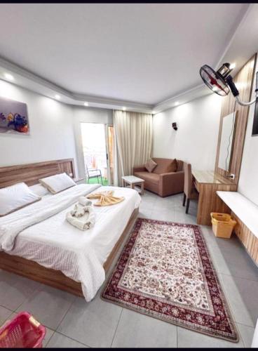 a bedroom with a bed and a living room at The Comfortable palace in Hurghada
