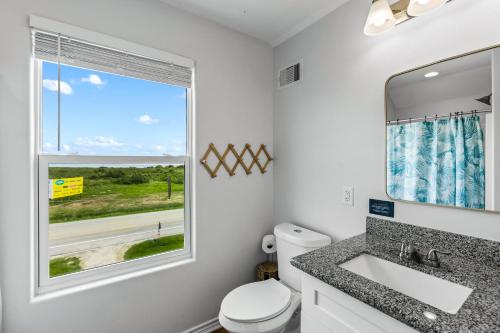 a bathroom with a sink and a window at Spacious Beachfront 5BR with Gorgeous Ocean views - Blue Footed in Bolivar Peninsula