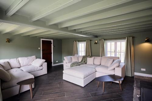 a living room with two white couches and chairs at Rose Cottage - Sands Farm in Wilton