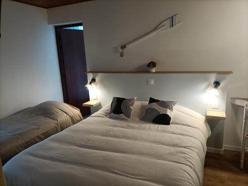 a bedroom with a bed with two pillows on it at La Sterne in Saint-Gilles-Croix-de-Vie