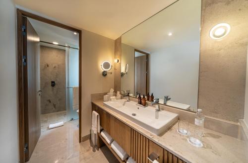 a bathroom with a sink and a large mirror at Grand Velas Riviera Nayarit-All Inclusive in Nuevo Vallarta