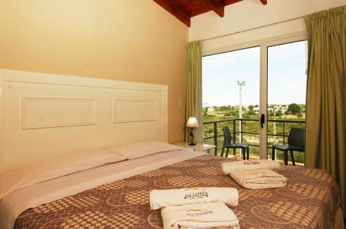 En eller flere senge i et værelse på Complejo Ali Lafken