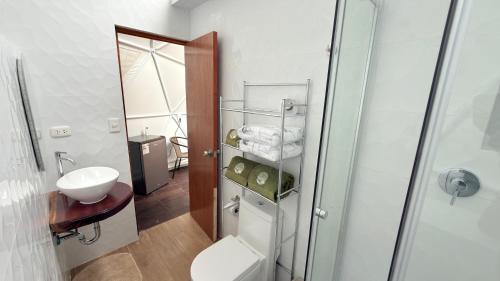 a bathroom with a toilet and a sink at Shapaja Glamping in Tarapoto