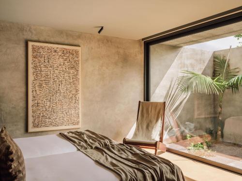 a room with a bed and a window at Residence - Signature Villas in Lagoa
