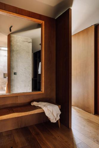 a bathroom with a mirror and a bed in it at Residence - Signature Villas in Lagoa