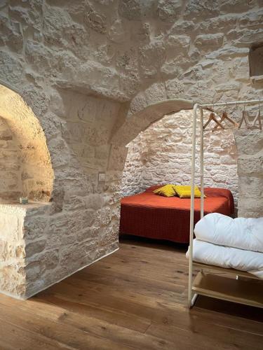a bedroom with a bed in a stone wall at Al Settimo Chilometro in Gioia del Colle